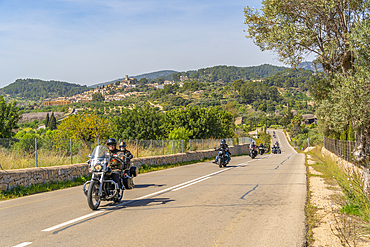 View of motor cyclists and hilltop town of Selva, Majorca, Balearic Islands, Spain, Mediterranean, Europe