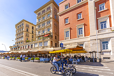 View of pastel coloured architecture, restaurants and cafes on seafront of Via Partenope, Naples, Campania, Italy, Europe