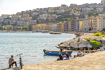 View of pastel coloured architecture on waterfront of Via Francesco Caracciolo, Naples, Campania, Italy, Europe