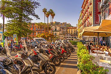 View of motorcycles, restaurant and colourful architecture in Piazza della Vittoria, Naples, Campania, Italy, Europe