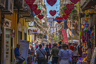 View of shops and decor on bustling Via San Biagio Dei Librai, Naples, Campania, Italy, Europe