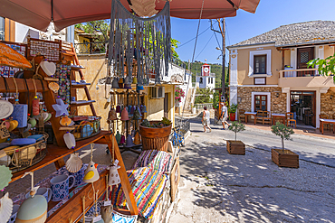 View of souvenirs, clock tower of Greek Orthodox Church and restaurant, Theologos, Thassos, Aegean Sea, Greek Islands, Greece, Europe