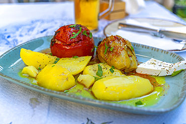 View of stuffed pepper and tomato with new potatoes in Thassos Town, Thassos, Aegean Sea, Greek Islands, Greece, Europe