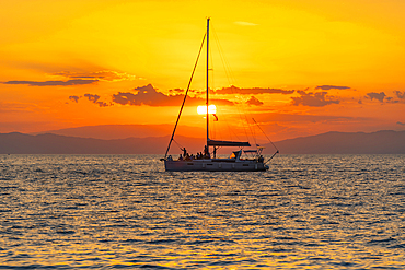 View of sailboat, sunset and Aegean Sea from Thassos Town, Thassos, Aegean Sea, Greek Islands, Greece, Europe