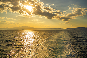 View of Greek mainland from ferry at sunset, Kavala, Dimos Kavalas, Eastern Macedonia and Thrace, Gulf of Thasos, Gulf of Kavala, Greece, Europe