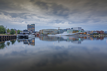 View of Oslo Opera House and Munch Museum reflecting in harbour on cloudy day, Oslo, Norway, Scandinavia, Europe