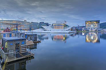 View of saunas, Oslo Opera House and Munch Museum reflecting in harbour on cloudy evening, Oslo, Norway, Scandinavia, Europe