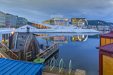 View of saunas, Oslo Opera House and Munch Museum reflecting in harbour on cloudy evening, Oslo, Norway, Scandinavia, Europe