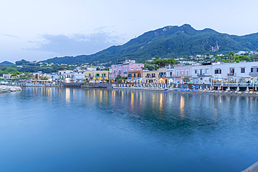 View of beach and the town of Lacco Ameno at dusk, Island of Ischia, Campania, Italy, Europe