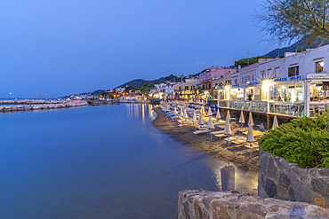 View of beach and the town of Lacco Ameno at dusk, Island of Ischia, Campania, Italy, Europe