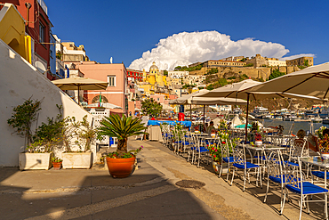 View of restaurants in Marina di Corricella and Eglise Santa Maria delle Grazie in background, Procida, Phlegraean Islands, Gulf of Naples, Campania, Southern Italy, Italy, Europe