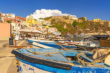 View of boats in Marina di Corricella and Eglise Santa Maria delle Grazie in background, Procida, Phlegraean Islands, Gulf of Naples, Campania, Southern Italy, Italy, Europe