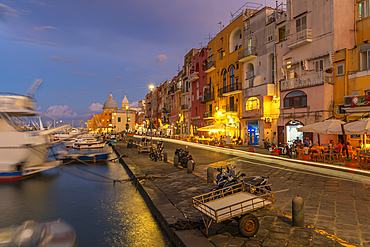 View of shops in the fishing port Marina Grande with trail lights at dusk, Procida, Phlegraean Islands, Gulf of Naples, Campania, Southern Italy, Italy, Europe