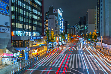 View of city street and trail lights at night, Minato City, Tokyo, Honshu, Japan