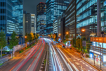 View of city street and trail lights at night, Minato City, Tokyo, Honshu, Japan