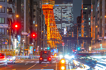 View of Tokyo Tower, city street and trail lights at night, Minato City, Tokyo, Honshu, Japan