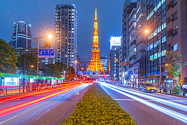 View of Tokyo Tower, city street and trail lights at night, Minato City, Tokyo, Honshu, Japan