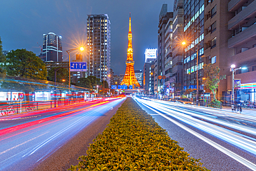 View of Tokyo Tower, city street and trail lights at night, Minato City, Tokyo, Honshu, Japan