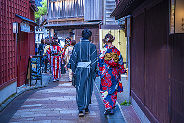 View of local couple in Kimono dress and traditional dark wood buildings in the Higashi Chaya District, Kanazawa City, Ishikawa Prefecture, Honshu, Japan, Asia