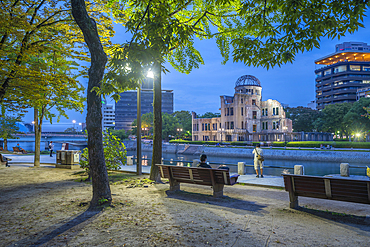 View of the skeletal ruins of the A-Bomb Dome from Hiroshima Peace Gardens at dusk, UNESCO World Heritage Site, Hiroshima, Honshu, Japan, Asia