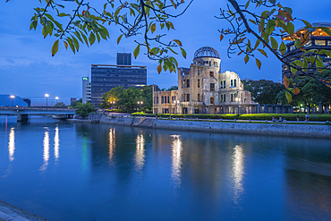 View of the skeletal ruins of the A-Bomb Dome from Hiroshima Peace Gardens at dusk, UNESCO World Heritage Site, Hiroshima, Honshu, Japan, Asia