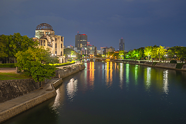 View of the skeletal ruins of the A-Bomb Dome from Hiroshima Peace Gardens at dusk, UNESCO World Heritage Site, Hiroshima, Honshu, Japan, Asia