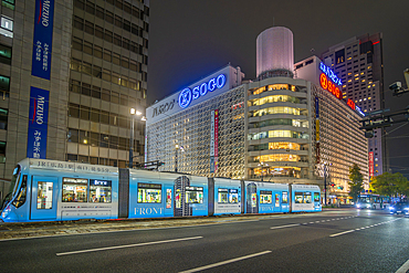 View of street scene, city tram and buildings in Hiroshima at night, Hiroshima, Honshu, Japan