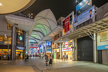 View of colourful shops and restaurants in shopping arcade at night, Hiroshima, Honshu, Japan