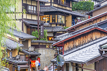 View of busy street and traditional wooden houses in Gion, Kyoto Geisha District, Kyoto, Honshu, Japan