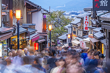 View of busy street and traditional wooden houses and shops in Gion, Kyoto Geisha District, Kyoto, Honshu, Japan