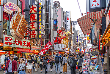 View of colourful signs of restaurants in Dotonbori, vibrant entertainment district near the river, Osaka, Honshu, Japan