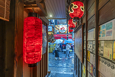 View of Japanese lanterns in dark alleyway in Dotonbori, vibrant entertainment district near the river, Osaka, Honshu, Japan