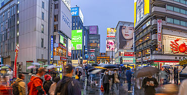 View of colourful adverts in Dotonbori, vibrant entertainment district near the river at dusk, Osaka, Honshu, Japan