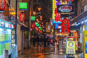 View of colourful signs in backstreet in Dotonbori, vibrant entertainment district near the river, Osaka, Honshu, Japan