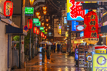 View of colourful signs in backstreet in Dotonbori, vibrant entertainment district near the river, Osaka, Honshu, Japan