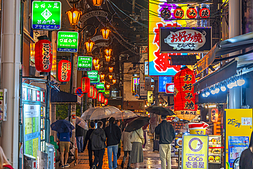 View of colourful signs in backstreet in Dotonbori, vibrant entertainment district near the river, Osaka, Honshu, Japan