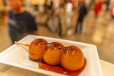 View of Dango made from rice flour in Dotonbori, vibrant entertainment district near the river, Osaka, Honshu, Japan