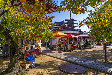 View of market stalls and Shitenno-ji Gojunoto (Five Story Pagoda) on a sunny day, Shitennoji, Tennoji Ward, Osaka, Honshu, Japan, Asia