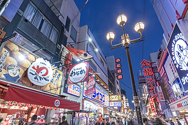 View of colourful facades of restaurants in Dotonbori, vibrant entertainment district near the river, Osaka, Honshu, Japan