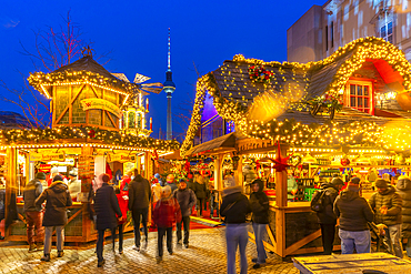 View of Christmas market stalls in Vorplatz Berliner Schloss at Christmas and Berlin TV Tower in background, Mitte, Berlin, Germany, Europe