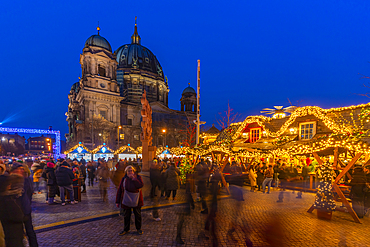 View of Christmas market stalls in Vorplatz Berliner Schloss at Christmas and Berlin Cathedral in background, Mitte, Berlin, Germany, Europe