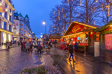 View of cafes, bars and Christmas market on Karl Johans Gate during winter at dusk, Oslo, Norway, Scandinavia, Europe