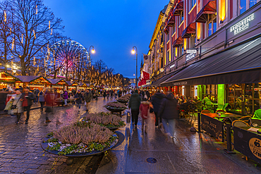 View of cafes, bars and Christmas market on Karl Johans Gate during winter at dusk, Oslo, Norway, Scandinavia, Europe