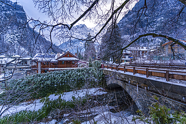 View of hotels and lodges with mountains in background during winter, Courmayeur, Aosta Valley, Italy, Europe