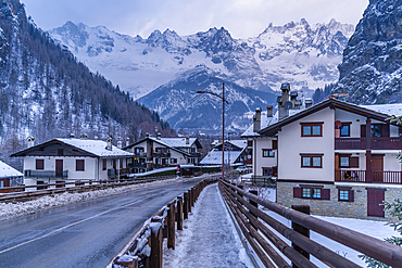 View of hotels and lodges with mountains in background during winter, Courmayeur, Aosta Valley, Italy, Europe