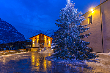 View of Christmas tree and decorations in Piazza Abbé Henry at dusk, Courmayeur, Aosta Valley, Italy, Europe