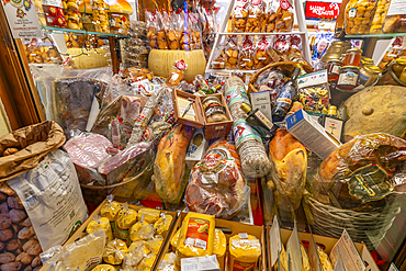 View of food shop window on via Roma at dusk, Courmayeur, Aosta Valley, Italy, Europe