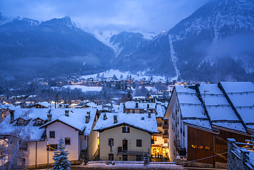 View of the snow covered town centre and mountainous background in winter, Courmayeur, Aosta Valley, Italy, Europe