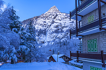 View of chalets and snow covered mountains in Courmayeur before dawn during winter, Courmayeur, Aosta Valley, Italy, Europe