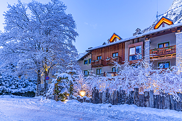 View of hotel and snow covered mountains in Courmayeur before dawn during winter, Courmayeur, Aosta Valley, Italy, Europe